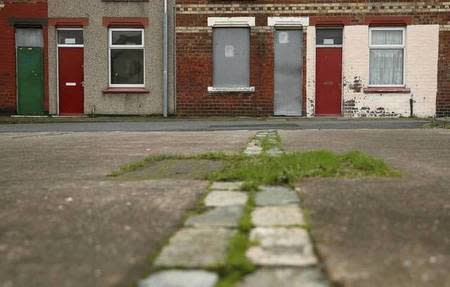 Houses with painted red doors are seen on a terraced street in the Gresham area of Middlesbrough, northern Britain, January 20, 2016. REUTERS/Phil Noble