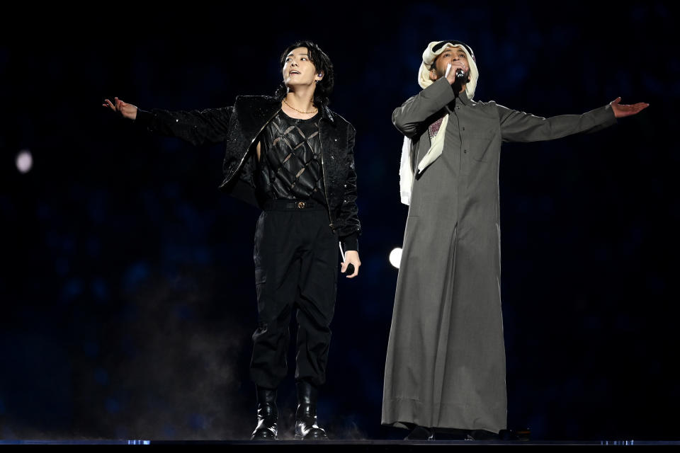 AL KHOR, QATAR - NOVEMBER 20: Jung Kook of BTS performs with Fahad Al Kubaisi during the opening ceremony prior to the FIFA World Cup Qatar 2022 Group A match between Qatar and Ecuador at Al Bayt Stadium on November 20, 2022 in Al Khor, Qatar. (Photo by Michael Regan - FIFA/FIFA via Getty Images)