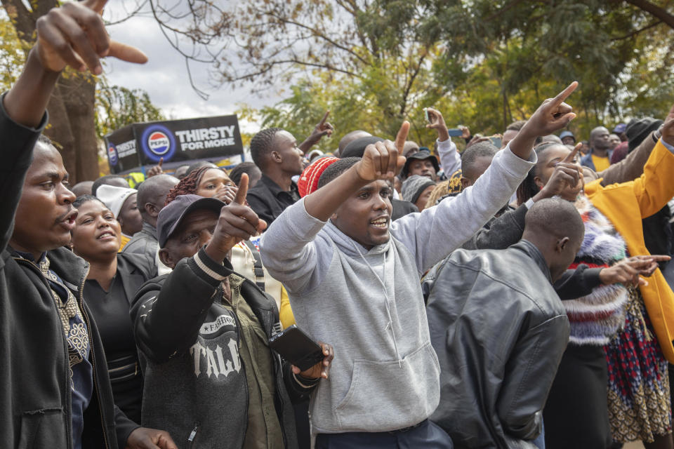 Opposition supporters protest outside a court, in Harare, Zimbabwe, Thursday, June 27, 2024. The protesters were angered by a magistrate's decision to deny bail to close to 80 activists arrested mid-June for allegedly meeting without official clearance. (AP Photo/Aaron Ufumeli)