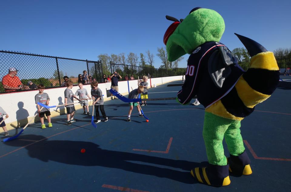 CBJ's mascot Stinger takes some time to work with the participants of the Blue Jackets' Get Out And Learn street-hockey session.