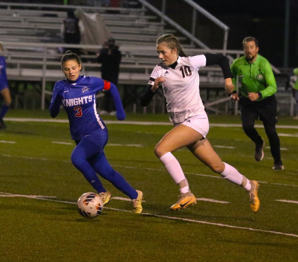 John Glenn's Riley Zamensky races past West Holmes' Kali Woods during Tuesday's 4-2 loss in the Division II regional semifinal.