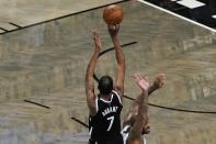 Brooklyn Nets' Kevin Durant (7) shoots over Milwaukee Bucks' P.J. Tucker to tie Game 7 in the second half during a second-round NBA basketball playoff series Saturday, June 19, 2021, in New York. (AP Photo/Frank Franklin II)