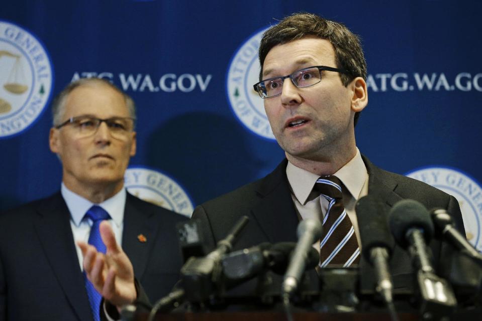 Washington Attorney General Bob Ferguson, right, talks to reporters as Gov. Jay Inslee, left, looks on, Monday, Jan. 30, 2017, in Seattle. Ferguson announced that he is suing President Donald Trump over an executive order that suspended immigration from seven countries with majority-Muslim populations and sparked nationwide protests. (AP Photo/Ted S. Warren)