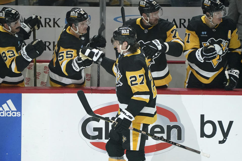 Pittsburgh Penguins' Ryan Graves (27) returns to the bench after scoring a goal against the Vegas Golden Knights during the first period of an NHL hockey game, Sunday, Nov. 19, 2023, in Pittsburgh. (AP Photo/Matt Freed)