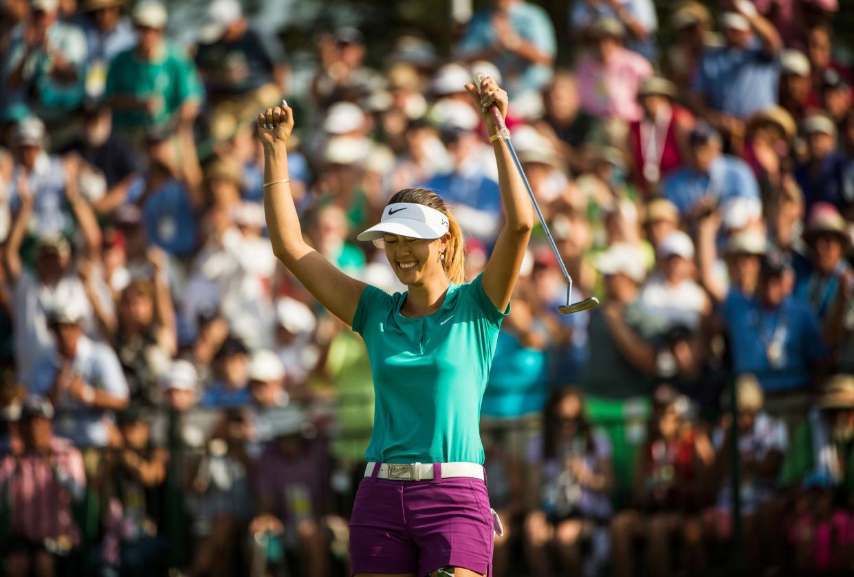 Michelle Wie celebrates after sinking her final put on the 18th green of Pinehurst No.2 winning the 2014 U.S. Women's Open, Sunday, June 22, 2014.