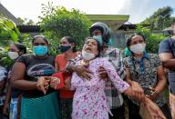 Family members of inmates react outside the prison, following unrest at Mahara Prison, in Colombo