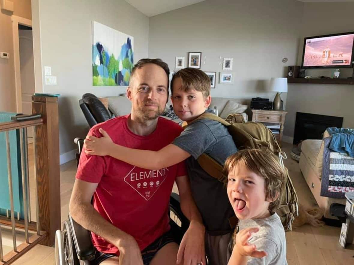 Ross Wightman is pictured next to his two kids after he was diagnosed with Guillain-Barré Syndrome. (Submitted by Toby Wilson - image credit)