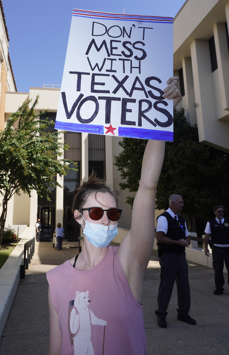 A protester holds a sign outside where Texas Gov Greg Abbott signed Senate Bill 1, also known as the election integrity bill, into law in Tyler, Texas, Tuesday, Sept. 7, 2021. The sweeping bill signed Tuesday by the two-term Republican governor further tightens Texas’ strict voting laws.(AP Photo/LM Otero)