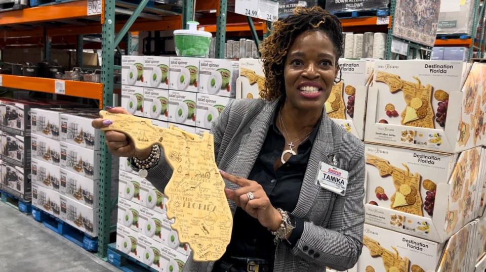 Tamika Barbel, one of the assistant general managers at the new Costco at One Daytona, shows off a Florida-shaped bamboo cutting/serving board during a preview tour of the new store on Tuesday, Feb. 20, 2024. The store officially opens 8 a.m. Thursday, Feb. 22.