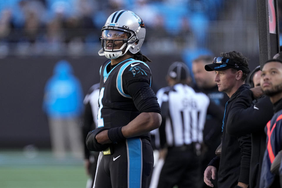 Carolina Panthers quarterback Cam Newton stands on the sidelines after leaving the game during the first half of an NFL football game against the Atlanta Falcons Sunday, Dec. 12, 2021, in Charlotte, N.C. (AP Photo/John Bazemore)