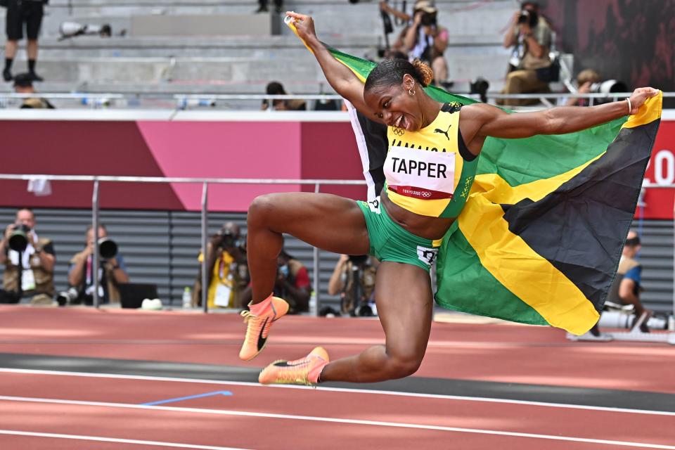 <p>Bronze medallist Jamaica's Megan Tapper celebrates after the women's 100m hurdles final during the Tokyo 2020 Olympic Games at the Olympic Stadium in Tokyo on August 2, 2021. (Photo by Ben STANSALL / AFP)</p> 