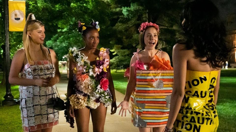 The main cast of the "Sex Lives of College Girls" stand on a sidewalk in costumes for a themed-college party