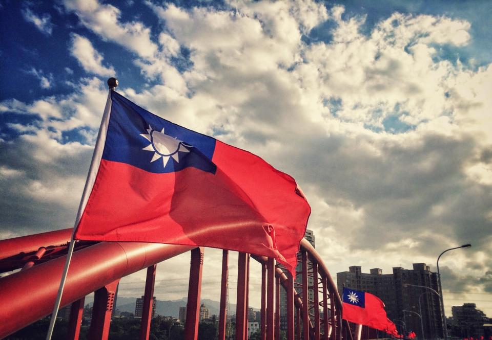 Taiwan Flags On Rainbow Bridge Against Cloudy Sky During Sunset