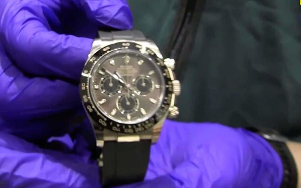 Agents seized luxury items including watches and cars - SOLARPIX