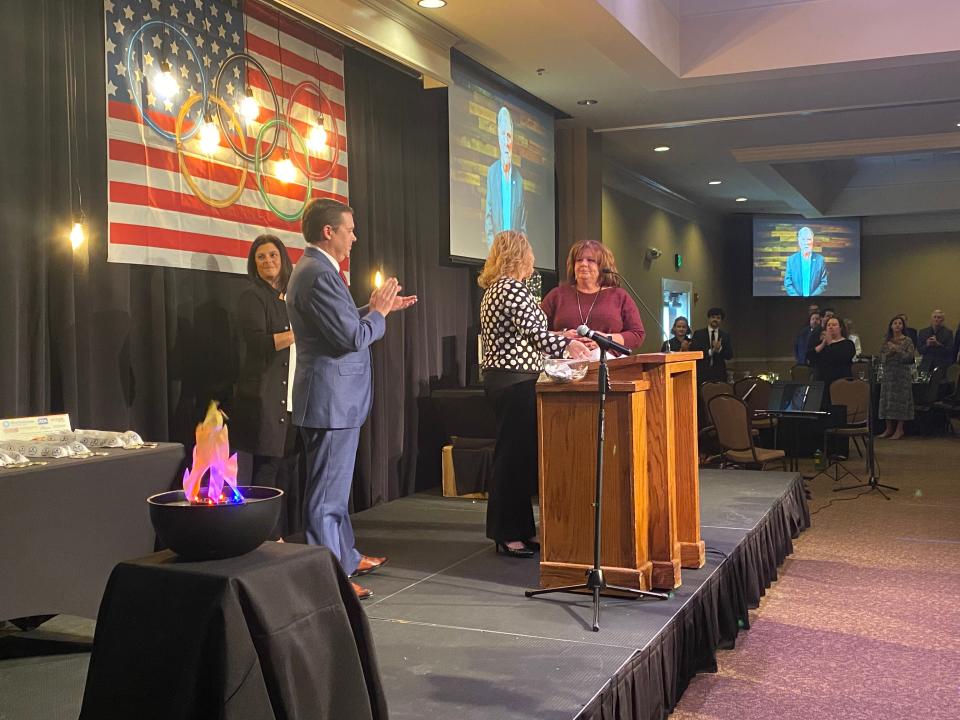 A tearful Kim Tedford (far right), regional director of the Madison County Health Department, accepts the award of "Best Leadership During a Crisis."