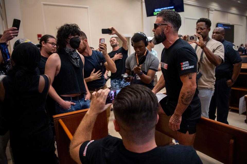 Members of the Goyim Defense League, wearing shirts with the words “Pro White” on the front and “Whites Against Replacement” argue with counter protesters while before being cleared out of the gallery at the Metro Council meeting at Historic Metro Courthouse in Nashville, Tenn., Tuesday, July 16, 2024.