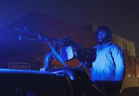 An Afghan policeman keeps watch at the scene of an explosion in Kabul January 17, 2014. REUTERS/Omar Sobhani