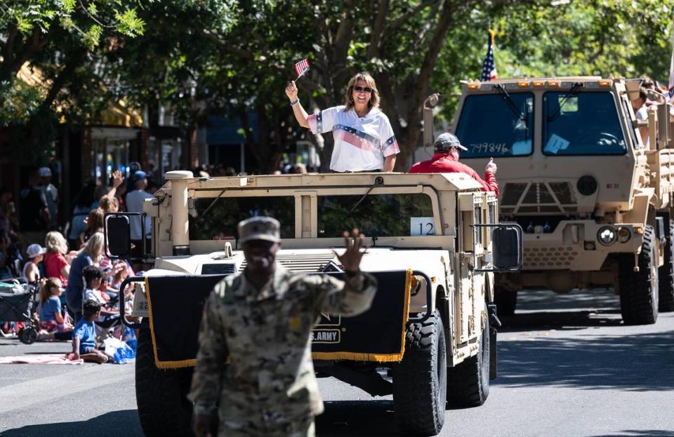 Turlock Mayor Amy Bublak rides with U.S. Army troops during the Turlock 4th of July parade on Main Street in Turlock Calif., on Saturday, July 2, 2022.