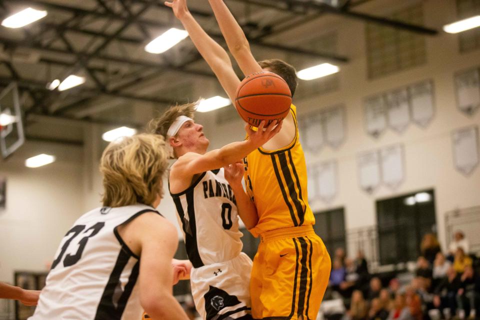 West Ottawa's Nash Bosma takes a shot around his East defender Tuesday, Dec. 20, 2022, at West Ottawa High School. 