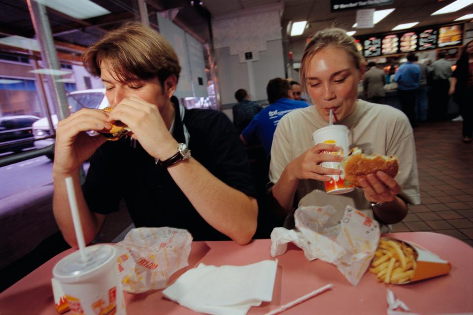 Two customers eating and drinking in a Burger King restaurant on September 10, 1997