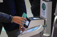 FILE - An employee has her certification checked as Italy's new "Green Pass" vaccination requirement for employees to enter their offices became mandatory, at the Trenitalia, Italian train company offices, in Rome, on Oct. 15, 2021. Italy is making life more uncomfortable for non-vaccinated people as the holidays near, excluding them from indoor restaurant dining, theaters and museums into the New Year in a bid to control the spread of coronavirus and encourage vaccine skeptics to get the shot. Starting Monday, Dec. 6, 2021 through Jan. 15, police can control whether diners seated in restaurants or bars have a "super" health pass certifying that they are either vaccinated or have recovered from the virus. (AP Photo/Andrew Medichini, File)