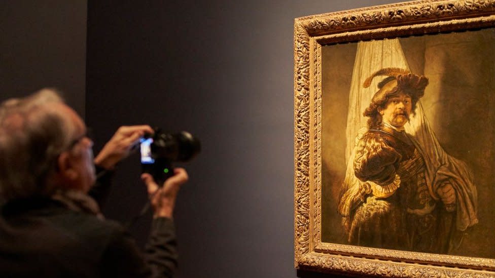 Un hombre retrata la pieza de Rembrandt, "El abanderado", en un museo