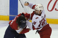 Carolina Hurricanes center Cedric Paquette (18) and Florida Panthers left wing Ryan Lomberg (94) fight during the first period at an NHL hockey game Thursday, April 22, 2021, in Sunrise, Fla. (AP Photo/Marta Lavandier)