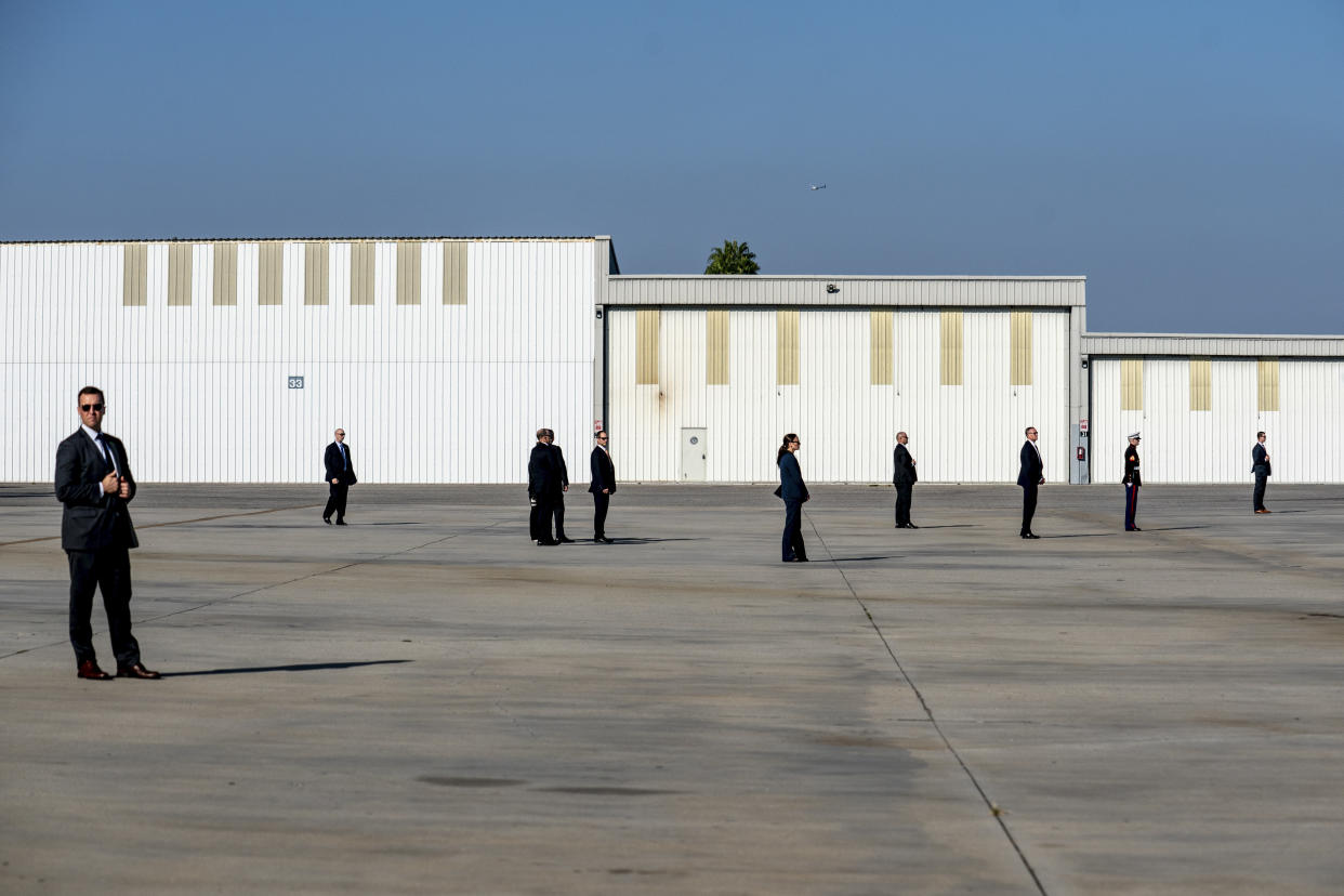 Secret Service Agents and staff wait for Marine One, carrying President Donald Trump, to land at the Downtown Los Angeles Landing Zone on Sept. 17, 2019. (Erin Schaff/The New York Times)