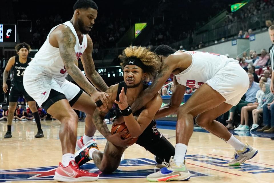 Mar 3, 2022; Dallas, Texas, USA;  Cincinnati Bearcats guard Mike Saunders Jr. (3) fights for possession against Southern Methodist Mustangs forward Marcus Weathers (50) and forward Franklin Agunanne (33) during the first half at Moody Coliseum.