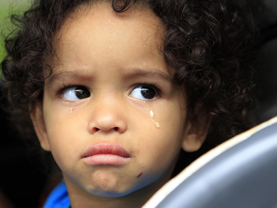 Jaden Fabian, 1, cries in her car seat as her family evacuates their home in Plaquemines Parish, La., Tuesday, Aug. 28, 2012, in advance of Isaac, which is expected to reach the swampy coast of southeast Louisiana by early Wednesday. The U.S. National Hurricane Center said the storm, with 75 mph (120 kph) winds, had gained strength as it moved over the warm, open waters of the Gulf of Mexico. (AP Photo/Gerald Herbert)