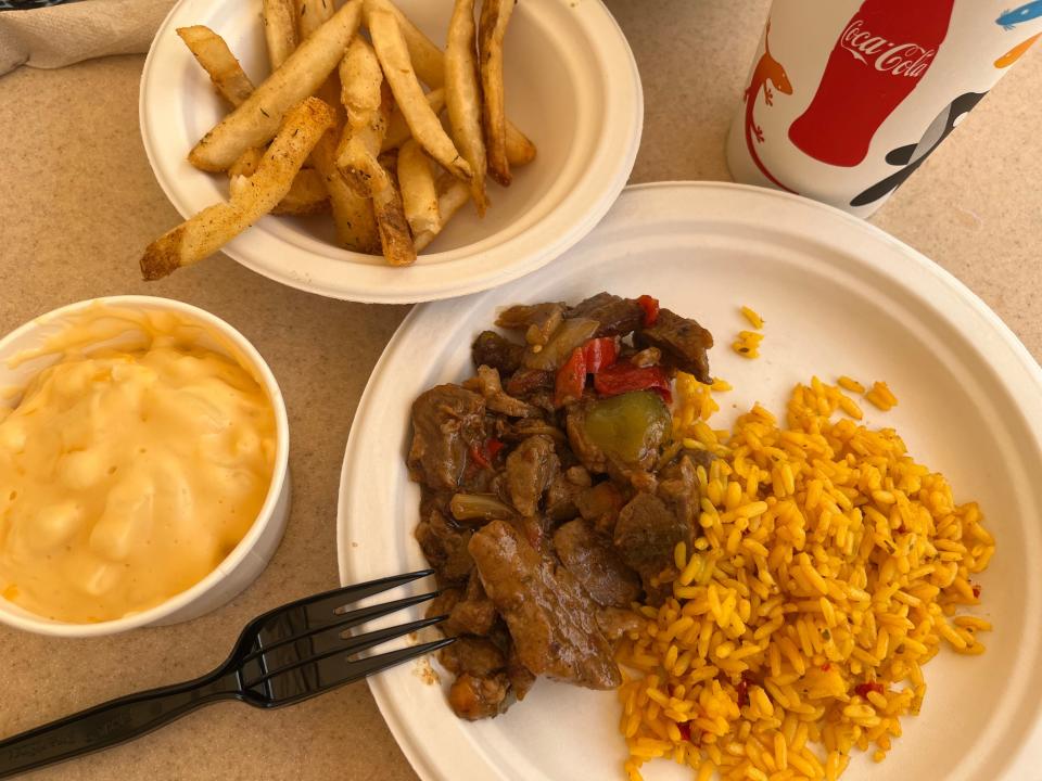 mac and cheese, meat and rice, and french fries at a food place in discovery cove in orlando