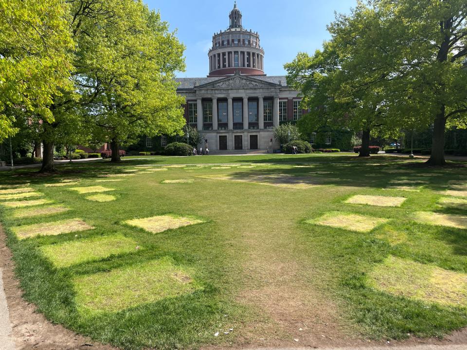 Outlines left in the grass on the Eastman quadrangle at the University of Rochester after campus security removed a tent encampment created by pro-Palestinian protesters.