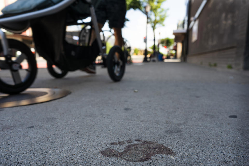 A bare bloody footprint remains on the sidewalk in the 2900 block of Hennepin Avenue after an early morning shooting, Sunday, June 21, 2020, in Minneapolis' Uptown neighborhood. The shooting in the popular nightlife area early Sunday left one man dead and multiple people wounded in a chaotic scene that sent people ducking into restaurants and other businesses for cover. (Jerry Holt/Star Tribune via AP)