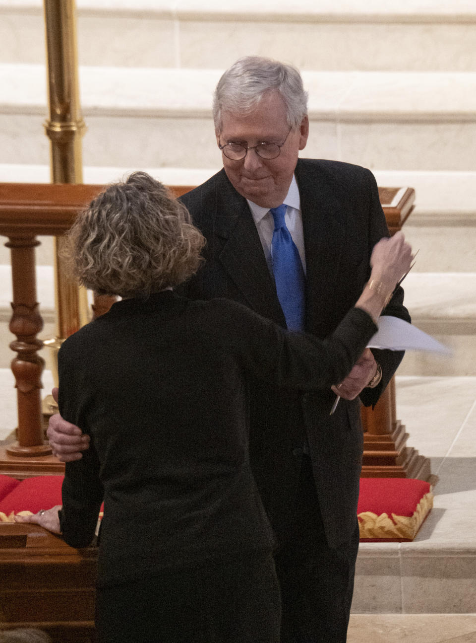 U.S. Sen. Mitch McConnell, R-Ky., embraces Diane Davison, wife of former Sen. Johnny Isakson's wife, during a funeral service for Isakson at Peachtree Road United Methodist Church, Thursday afternoon, Jan. 6, 2022, in Atlanta. Isakson, 76, died Dec. 19, 2021, at his home in Atlanta. (Ben Gray/Atlanta Journal-Constitution via AP)