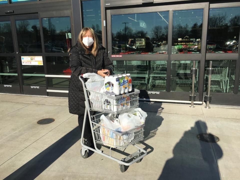 Shopper Judy Perlman leaves the Weis supermarket in Warminster Thursday with her food order.