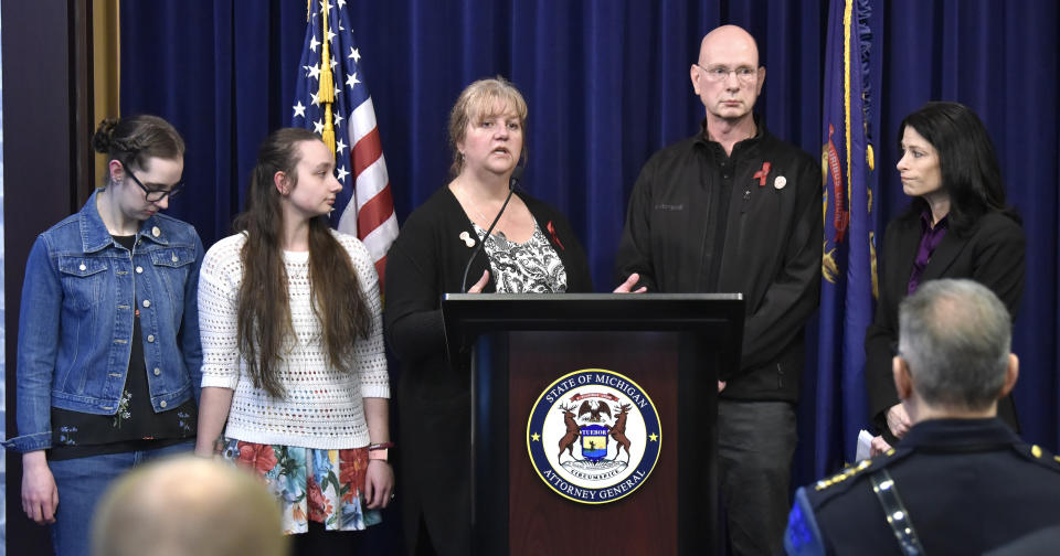 Michigan Attorney General Dana Nessel, right, listens as Danielle Stislicki's parents, Richard and Ann, address the media while Danielle's sisters, Jillian and Holly, listen during a press conference at which Nessel announced a first-degree murder charge against Floyd Galloway, Jr. for the murder of 28-year-old Danielle Stislicki, who went missing December 2, 2016 and has never been found. (Todd McInturf/Detroit News via AP)/Detroit News via AP)
