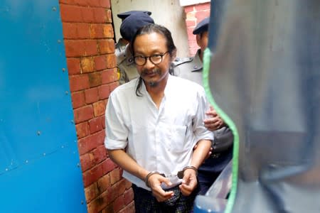 Filmmaker Min Htin Ko Ko Gyi walks out of the courtroom at Insein court in Yangon