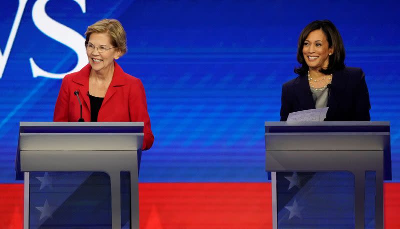 FILE PHOTO: Senator Elizabeth Warren and Senator Kamala Harris smile during the 2020 Democratic U.S. presidential debate in Houston