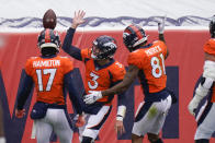 Denver Broncos quarterback Drew Lock (3) reacts with teammates wide receiver Tim Patrick (81) and wide receiver DaeSean Hamilton (17) after scoring a touchdown during the first half of an NFL football game against the Kansas City Chiefs, Sunday, Oct. 25, 2020, in Denver. (AP Photo/Jack Dempsey)
