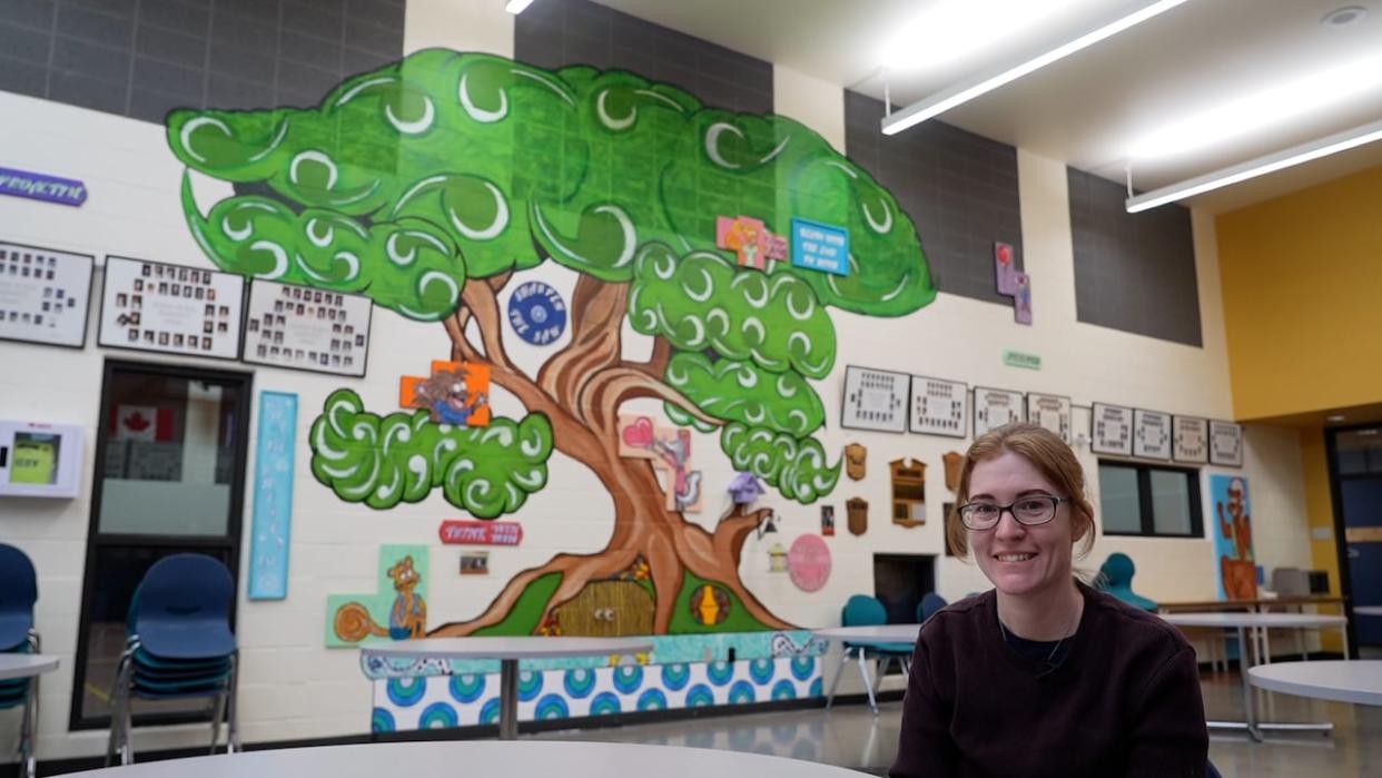 Jennifer Fawcett's children attend Granum school. She is the secretary of the parent council and her husband painted this mural in the main foyer. She says the community and school are deeply intertwined. (Ose Irete/CBC - image credit)