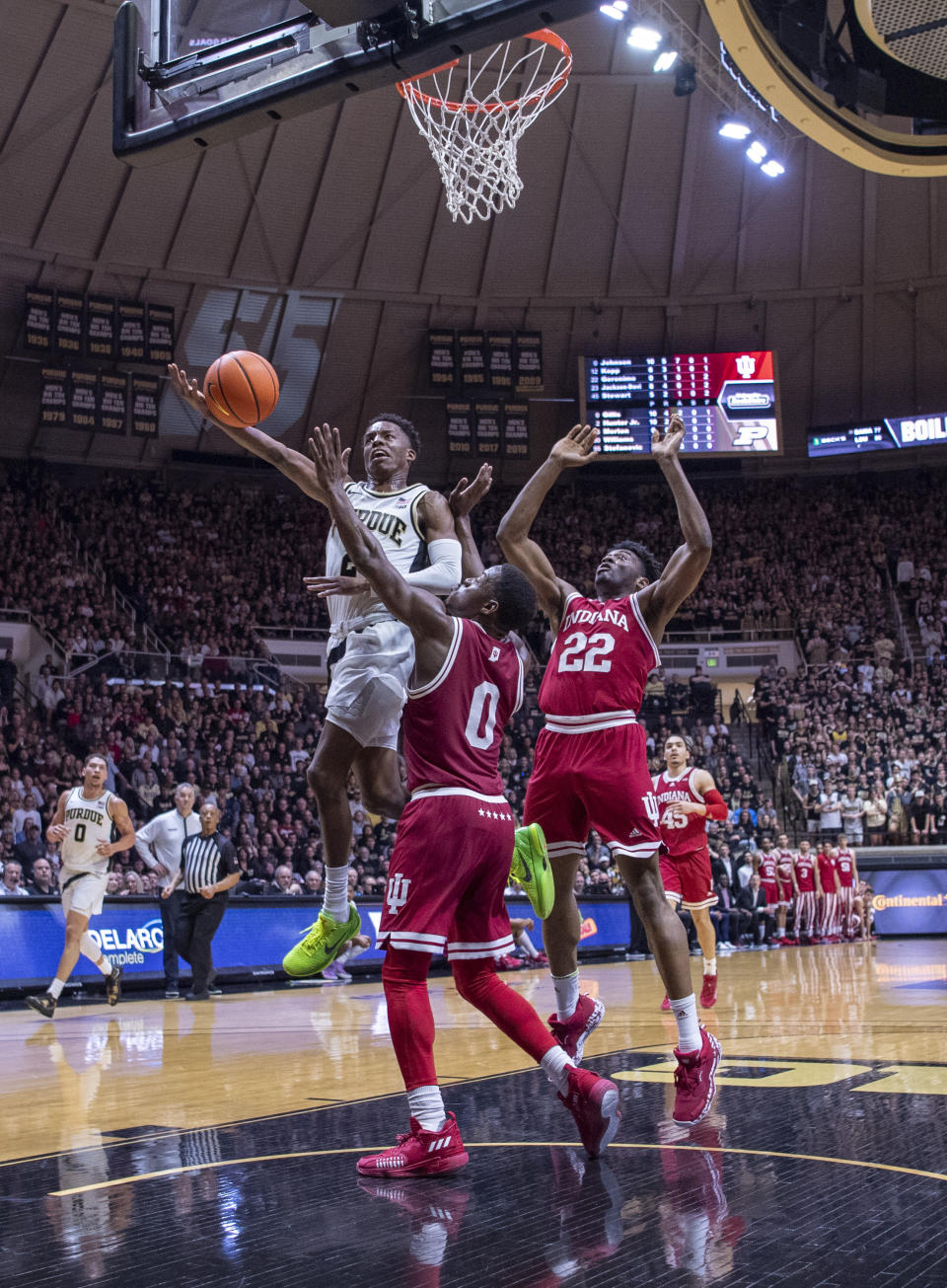 Purdue guard Eric Hunter Jr. (2) drives toward the basket to shoot while being defended by Indiana guard Xavier Johnson (0) and forward Jordan Geronimo (22) during the second half of an NCAA college basketball game, Saturday, March 5, 2022, in West Lafayette, Ind. (AP Photo/Doug McSchooler)