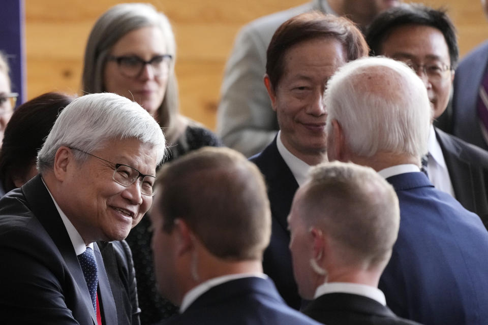 President Joe Biden, right, speaks with Taiwan Semiconductor Manufacturing Company CEO C.C. Wei, left, after speaking about jobs and the economy after touring the facility under construction in Phoenix, Tuesday, Dec. 6, 2022. (AP Photo/Ross D. Franklin)