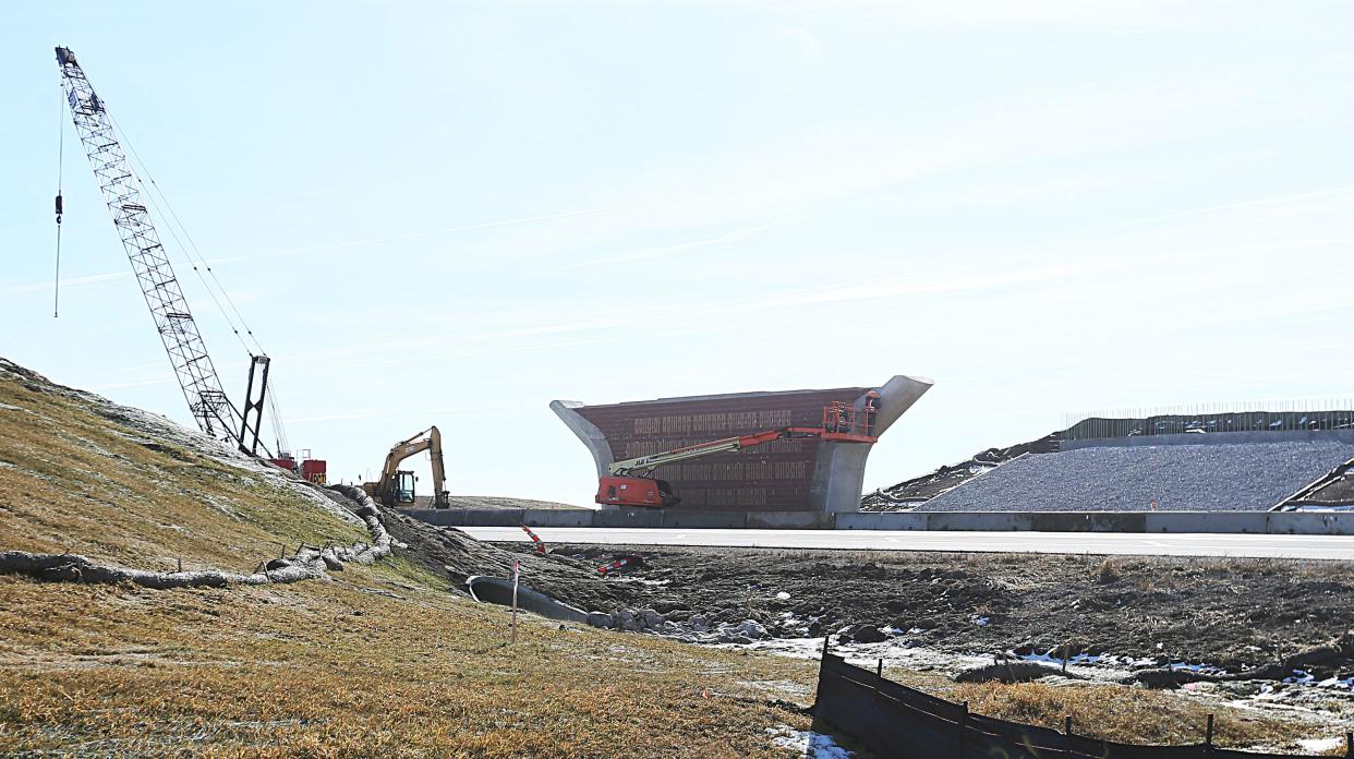 Constriction workers work on a new flyover bridge over HWY -30 between Ames and Nevada Monday, Feb. 19, 2024, near Ames, Iowa.