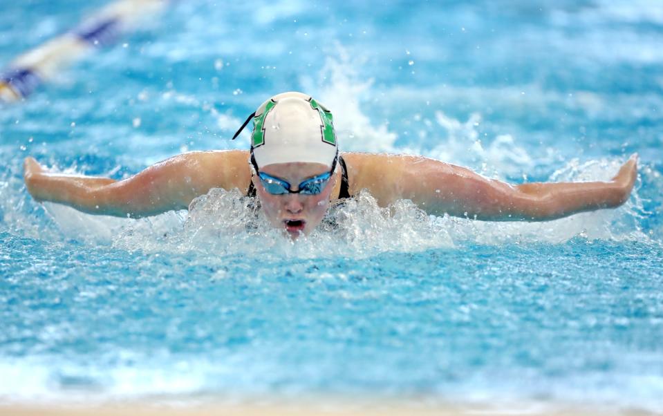 Bishop McGuinness' Macy Lewis swims in the 100-yard butterfly during the Class 5A state finals on Feb. 18, 2023, at Edmond Schools Aquatic Center.