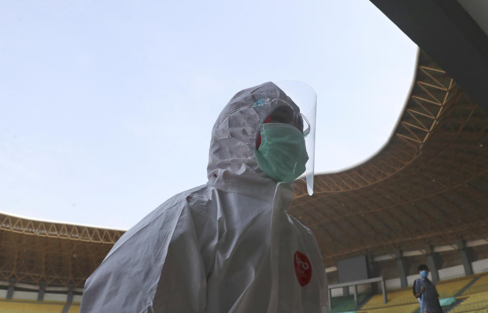 A medic walks at Patriot Candrabhaga stadium to make one of the rooms at the stadium a quarantine facility for people showing symptoms of the COVID-19 amid the new coronavirus outbreak in Bekasi on the outskirts of Jakarta, Indonesia Wednesday, Sept. 9, 2020. While Indonesia has recorded more deaths from the coronavirus than any other Southeast Asian country, it also has seen by far the most fatalities among medical workers in the region, leading to concerns about the long-term impact on the nation's fragile healthcare system. (AP Photo/Achmad Ibrahim)