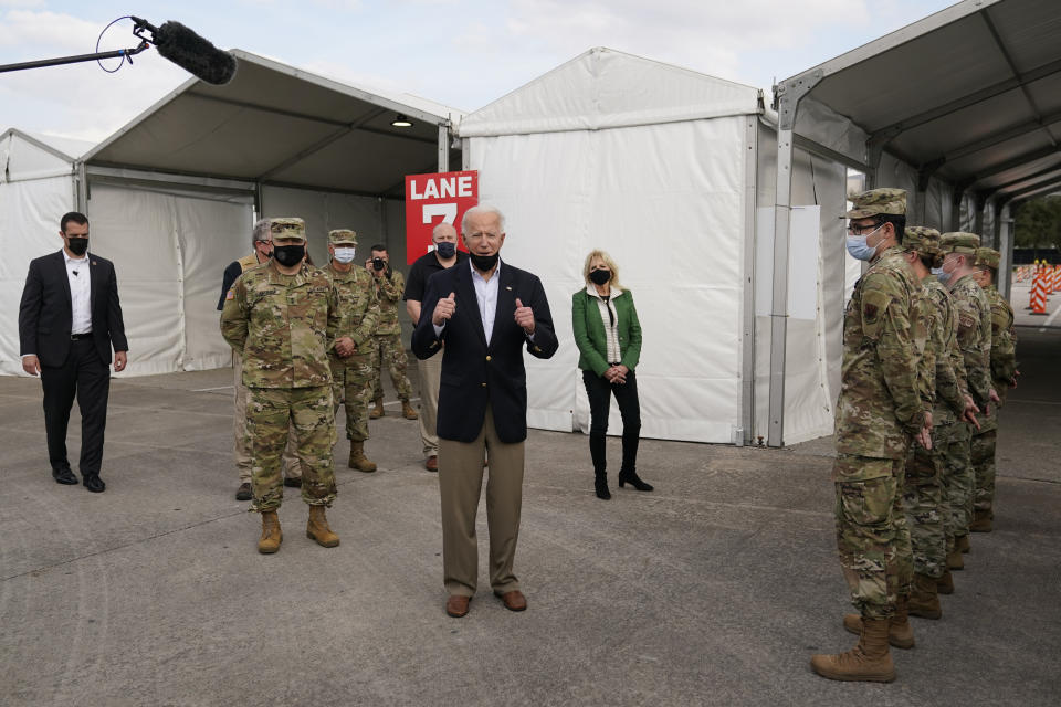 President Joe Biden speaks at a FEMA COVID-19 mass vaccination site at NRG Stadium, Friday, Feb. 26, 2021, in Houston. First lady Jill Biden looks on. (AP Photo/Patrick Semansky)