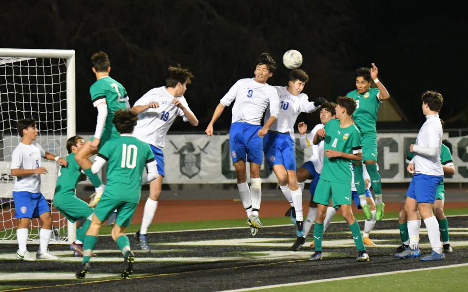 Westlake's Ric Fujita (No. 9) and Jaden Nachimzon (No. 10) both go up to head the ball during the Warriors' 1-0 win over Thousand Oaks in a Marmonte League match on Friday night.