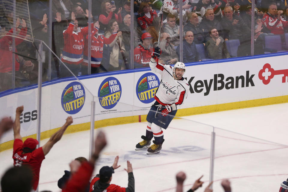 Washington Capitals forward Alex Ovechkin (8) celebrates a goal by teammate Dmitry Orlov during the third period of an NHL hockey game against the Buffalo Sabres, Monday, March 9, 2020, in Buffalo, N.Y. (AP Photo/Jeffrey T. Barnes)