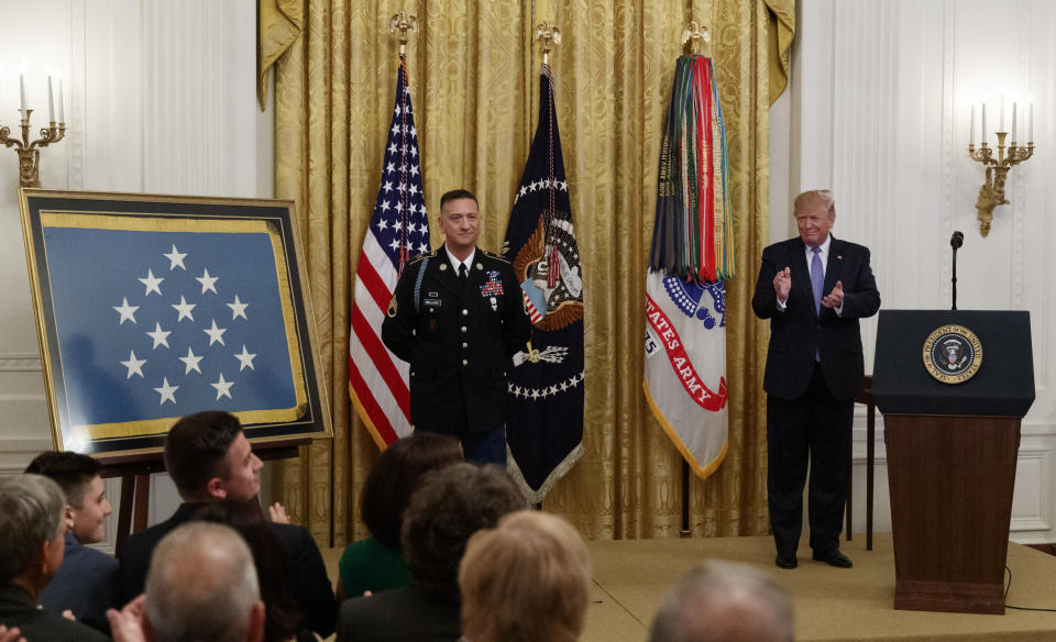 President Donald Trump applauds during a ceremony to award the Medal of Honor to Army Staff Sgt. David Bellavia in the East Room of the White House in Washington, Tuesday, June 25, 2019, for conspicuous gallantry while serving in support of Operation Phantom Fury in Fallujah, Iraq. (AP Photo/Carolyn Kaster)