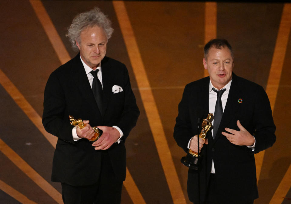 Charlie Mackesy and Matthew Freud accept the award for Animated Short Film for The Boy, the Mole, the Fox and the Horse during the Academy Awards on March 12.